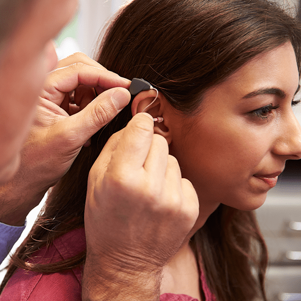 Fitting hearing aid with young woman