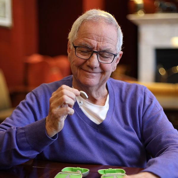 Man inspecting new hearing aids