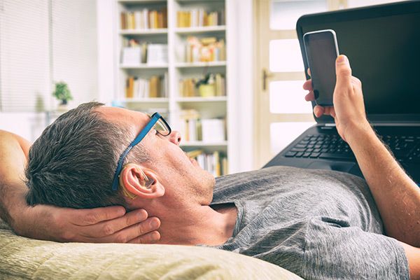 Man on mobile with hearing aid